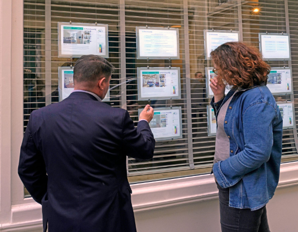 Rental specialist showing listings to a client